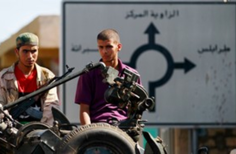 Libyan rebel fighters outside Tripoli 311 (R) (photo credit: REUTERS/Bob Strong)