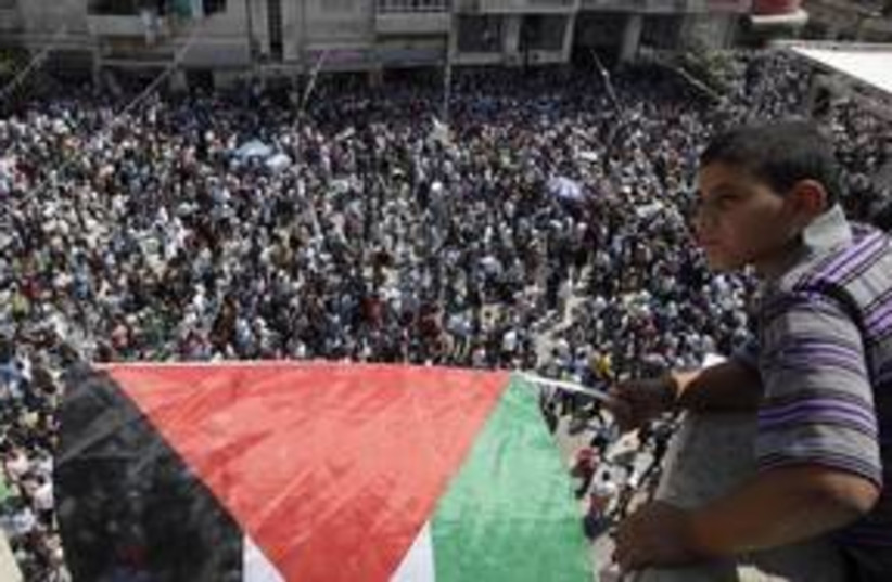 Palestinian boy looks over rally in Ramallah 311 (R) (photo credit: REUTERS/Darren Whiteside)