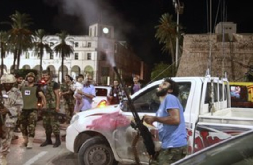 Libyan fires in air at Mo'tassim Gaddafi's capture_311 (photo credit: Reuters)