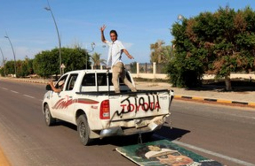 Anti-Gaddafi forces after fall of Sirte R 311 (photo credit: ESAM OMRAN AL-FETORI/ REUTERS)