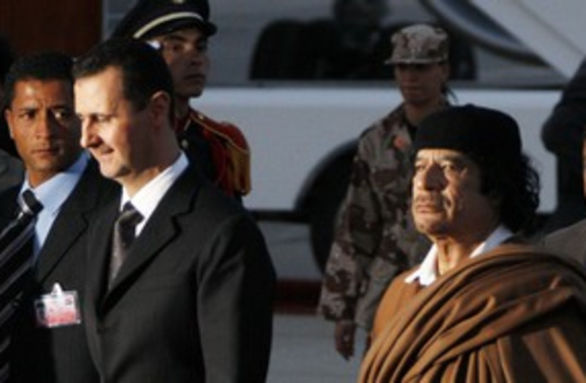 Syria's Bashar Assad with Muammar Gaddafi 311 (R) (photo credit: Khaled Al Hariri / Reuters)