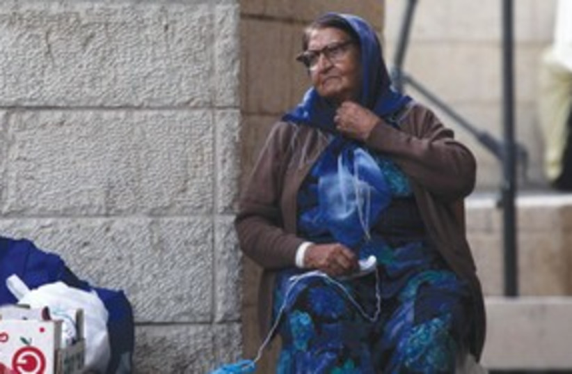 A poor woman poverty impoverished homeless 311 (photo credit: Marc Israel Sellem/The Jerusalem Post)