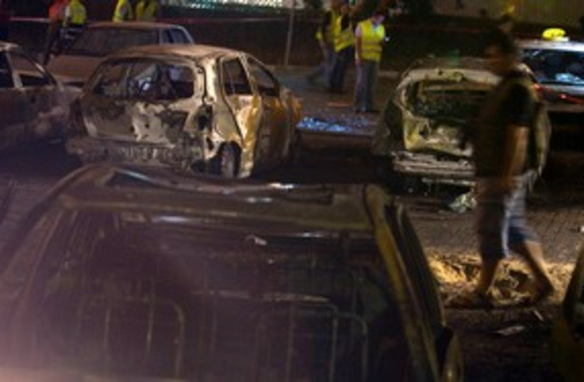Burned out cars hit by Grad rockets in Ashdod 311 (R) (photo credit: REUTERS/ Nir Elias)
