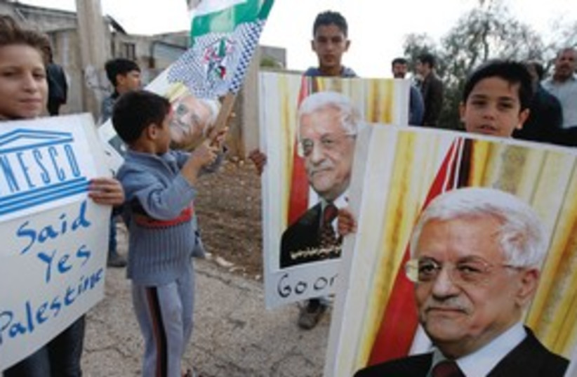 Kids with posters of PA President Mahmoud Abbas 311 (R) (photo credit: Abed Omar Qusini/Reuters)