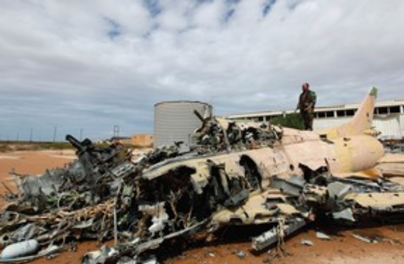 A destroyed aircraft in Sirte, Libya 311 (R) (photo credit: Reuters)