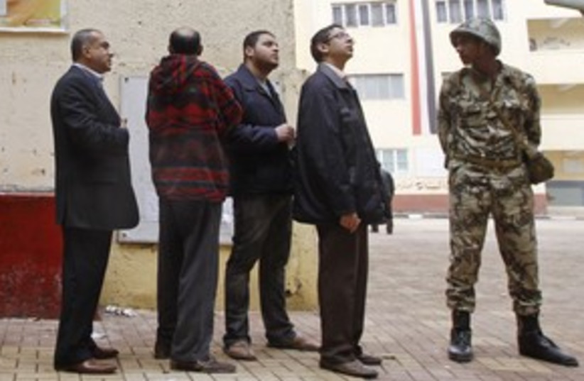 Egyptians, soldier at the polls_311 (photo credit: Reuters)