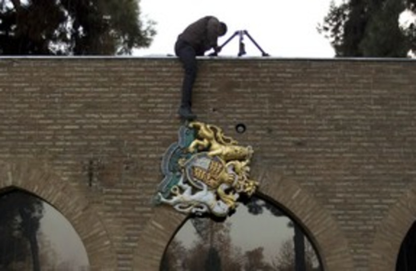 protesters remove UK emblem from embassy in Tehran_311 (photo credit: Reuters)