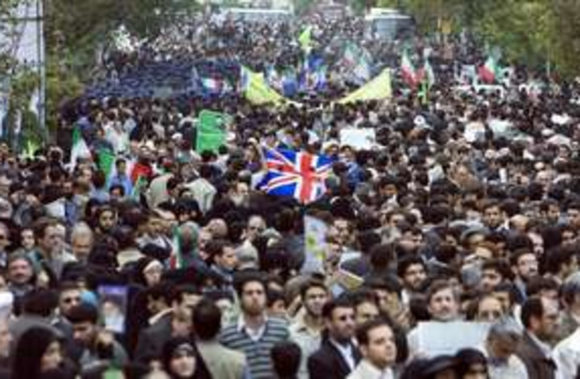 Iranian demonstrators carry a British flag (R) 311 (photo credit:  REUTERS/Raheb Homavandi)