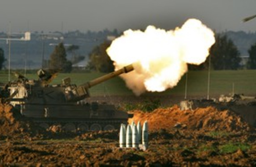 Mobile IDF artillery unit fires a shell 311 (R) (photo credit: Jerry Lampen / Reuters)