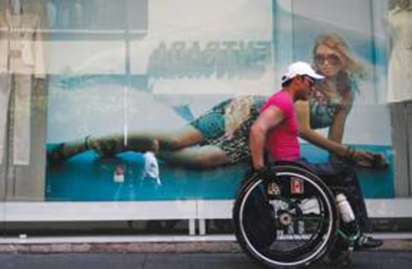 A man in a wheelchair [Illustrative]. (photo credit: Carlos Jasso/Reuters)