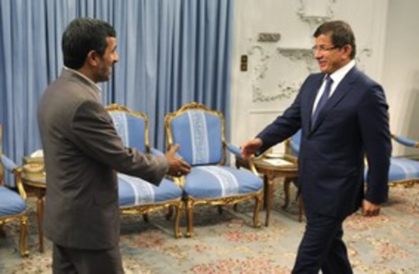 Iranian President Ahmadinejad, Turkish FM Davutoglu (R)_311 (photo credit: Reuters)