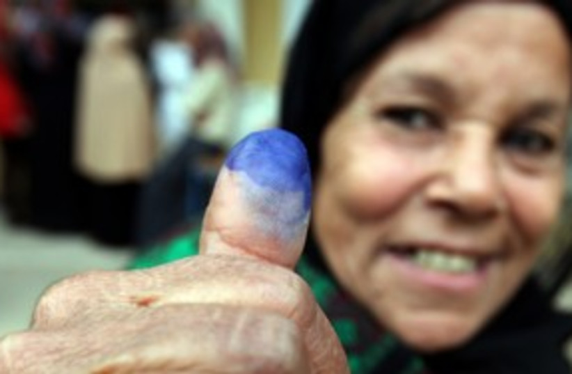 An Egyptian woman shows her stained finger after voting 311R (photo credit: REUTERS/Amr Abdallah Dalsh)