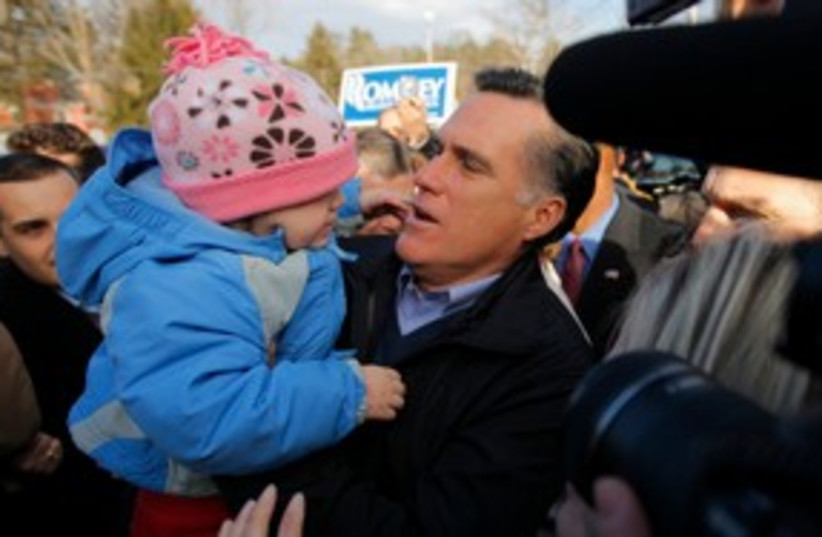 Mitt Romney holds a child at a campaign event 311 (R) (photo credit: REUTERS/Brian Snyder)