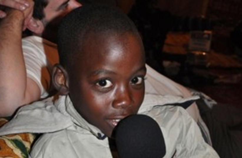Malian child holding Campos' IDC microphone 311 (photo credit: daniel campos)