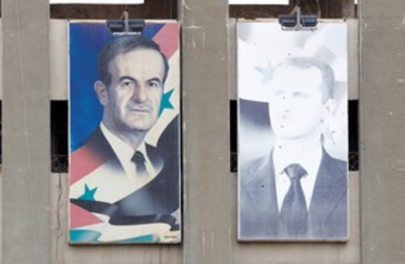Pictures of Bashar, Hafez Assad 311 (photo credit: Ahmed Jadallah/Reuters)