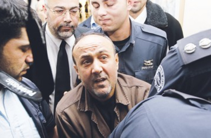 Barghouti before entering courtroom 390 (photo credit: Ammar Awad/Reuters)