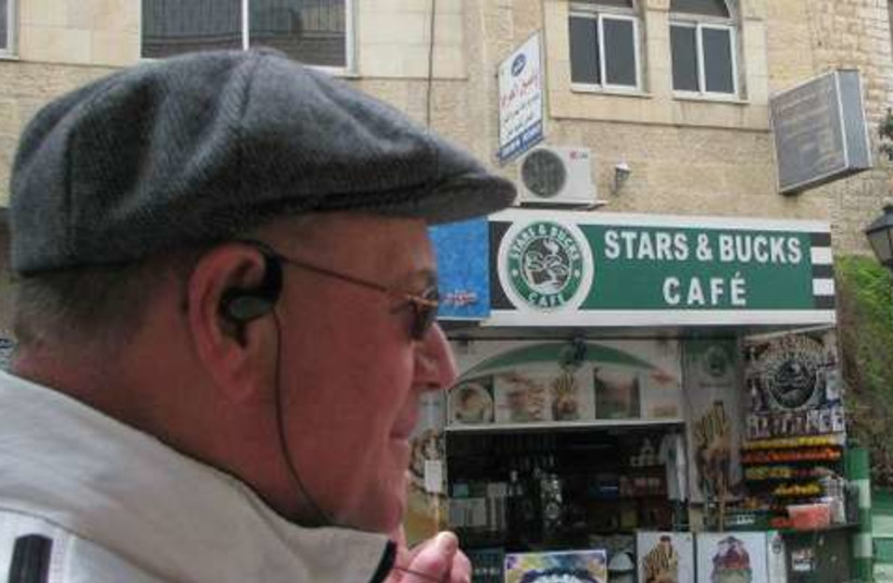 Archbishop Dolan outside Bethlehem's version of Starbucks (photo credit: DEBORAH DANAN)