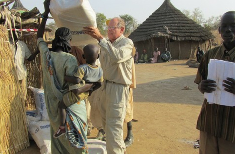 Charles Jacobs helps distribute aid packages in Sudan 521 (photo credit: Courtesy: Christian Solidarity International, USA)