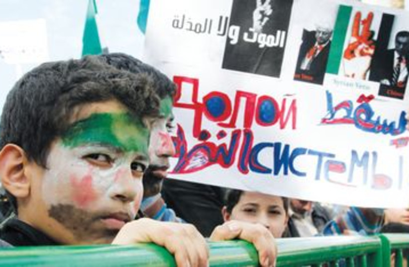 Children with faces painted with Syria oppositon flag colors (photo credit: REUTERS)