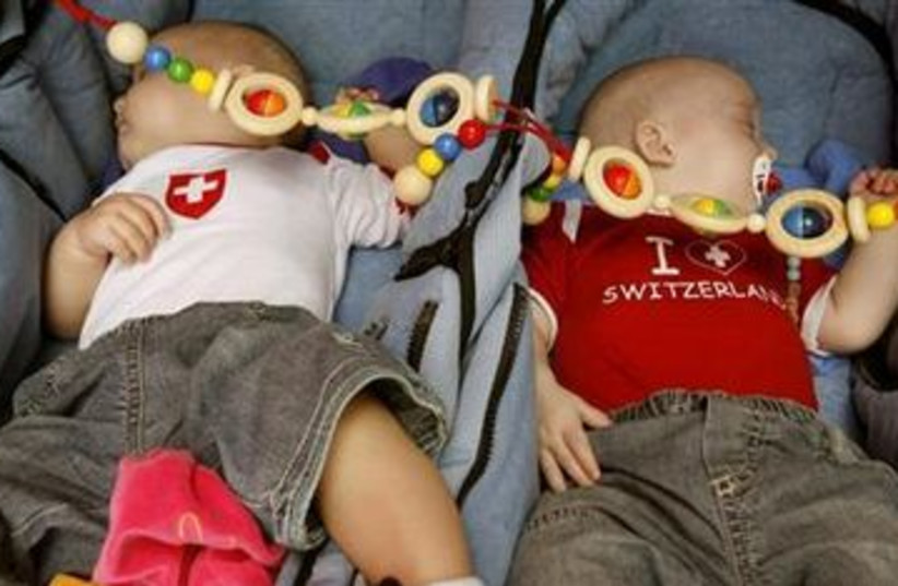 Twin babies sleeping 390 (R) (photo credit: Reuters/Arnd Wiegmann)