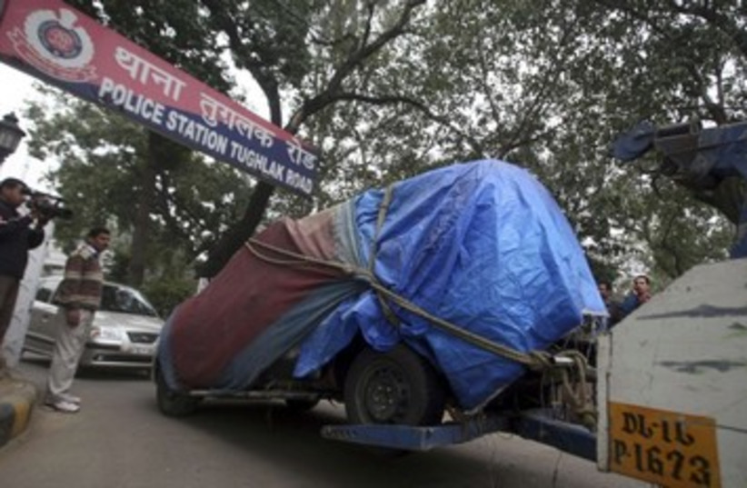 Israeli vehicle is towed away from embassy_390 (photo credit: Reuters)