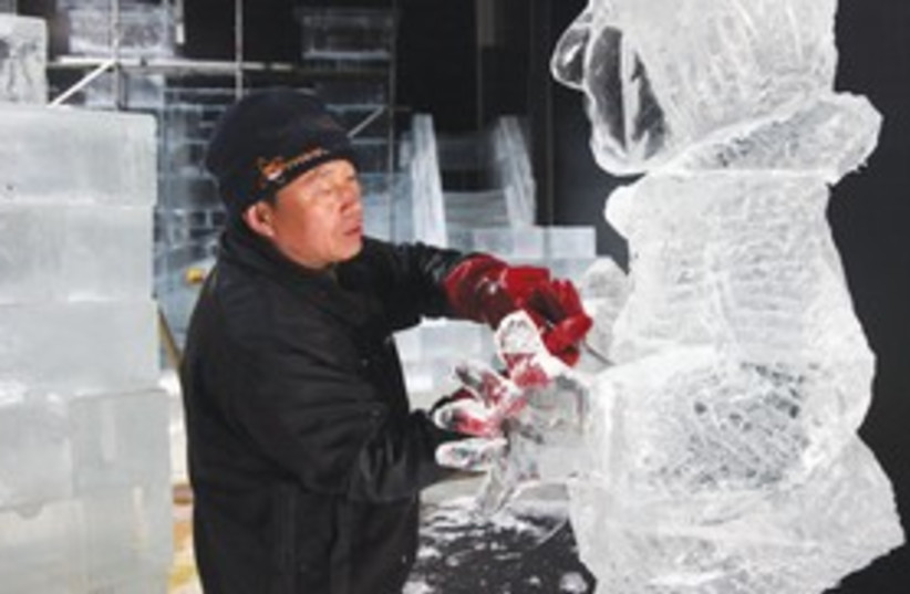 Ice carver from China building sculpture_390 (photo credit: Marc Israel Sellem/The Jerusalem Post)