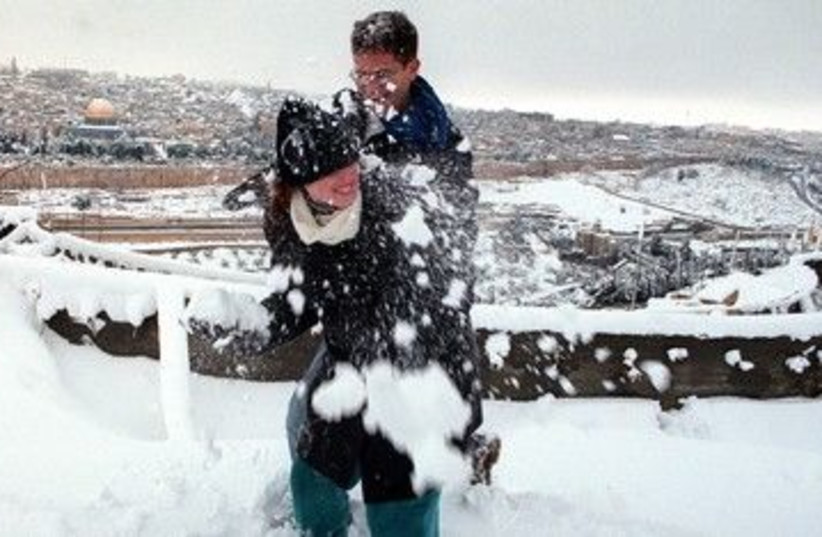 Couple playing in Jerusalem snow 390 (photo credit: REUTERS)
