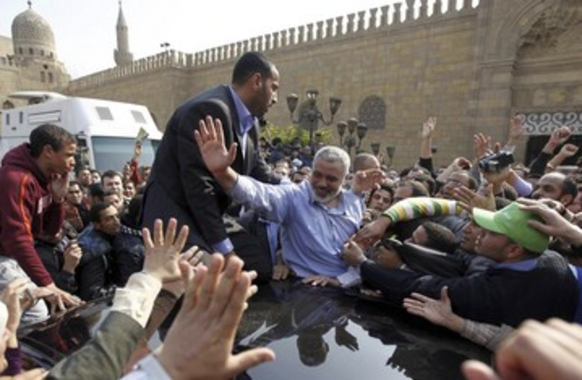 Haniyeh waves to supporters after Friday speech in Cairo 390 (photo credit: REUTERS/Mohamed Abd El Ghany)