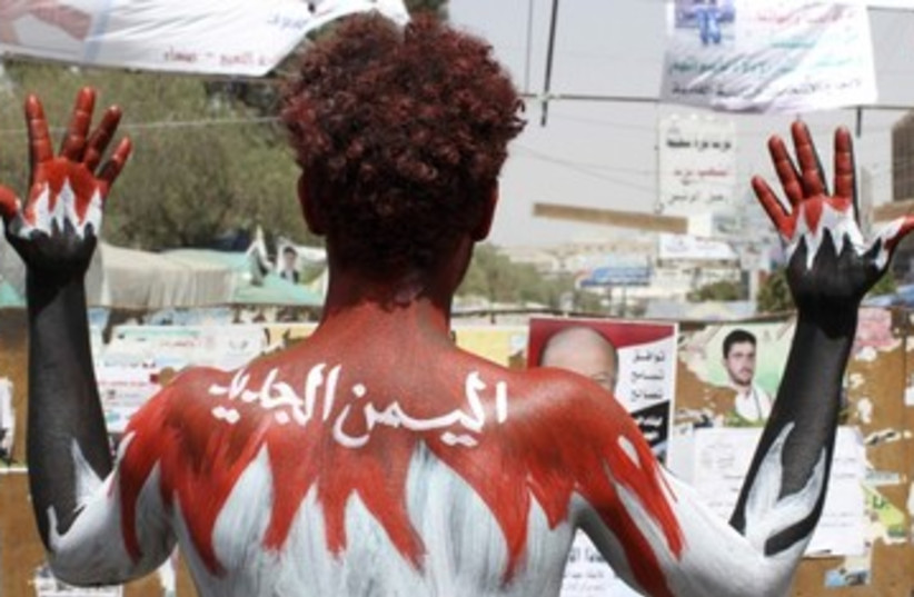 demonstrator paints his body in Yemen colors_390 (photo credit: Reuters)