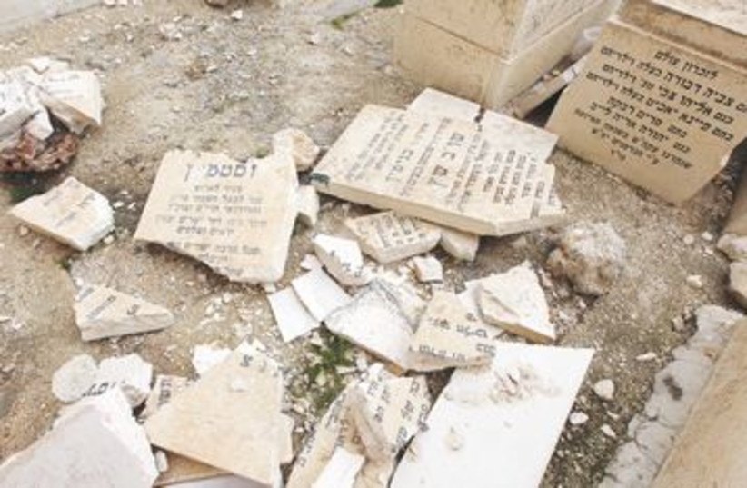 PIECES OF shattered Jewish grave stone at Mt. of Olives 390 (photo credit: Marc Israel Sellem/The Jerusalem Post)