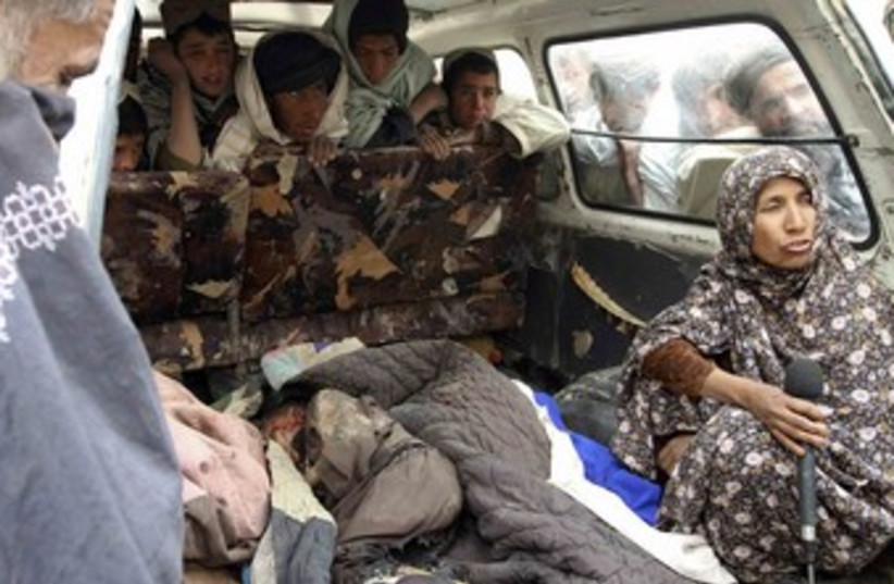 Afghan woman interviewed next to body of killed child_370 (photo credit: Ahmed Nadeem/Reuters)