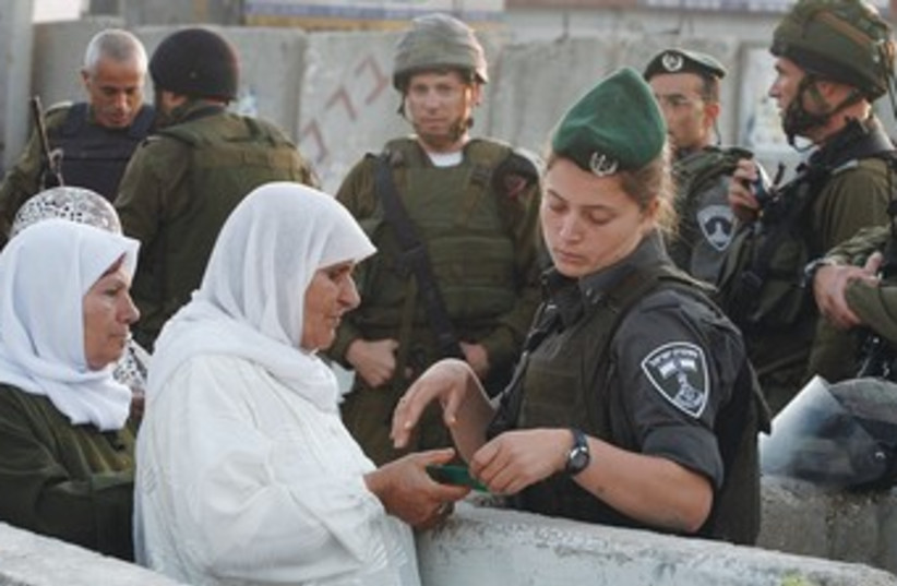 Palestinian women at the Kalandiya checkpoint 370 (R) (photo credit: Reuters)