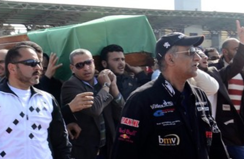Egyptian protesters carry coffin 370 (photo credit: REUTERS)