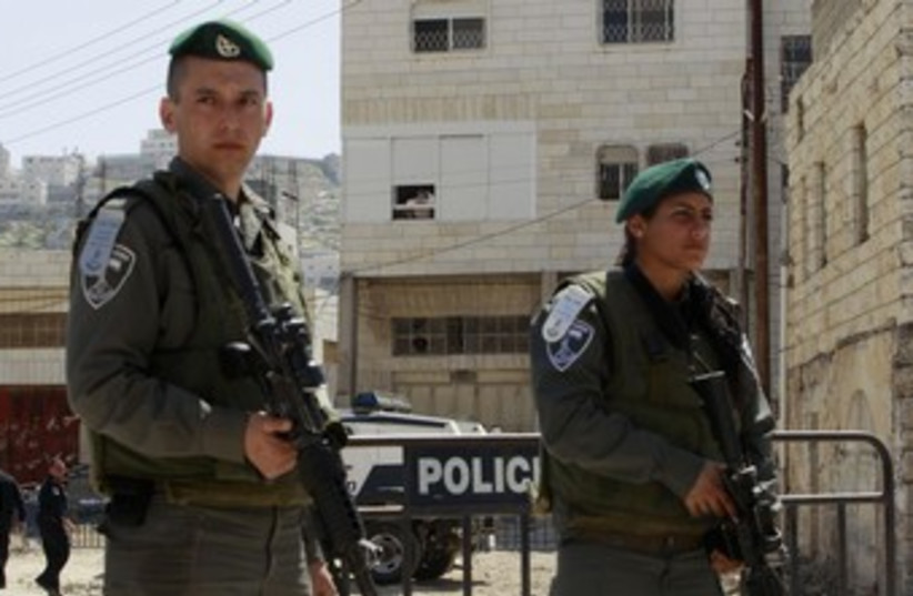 Israel border police stand guard in Hebron_370 (photo credit: Ammar Awad/Reuters)