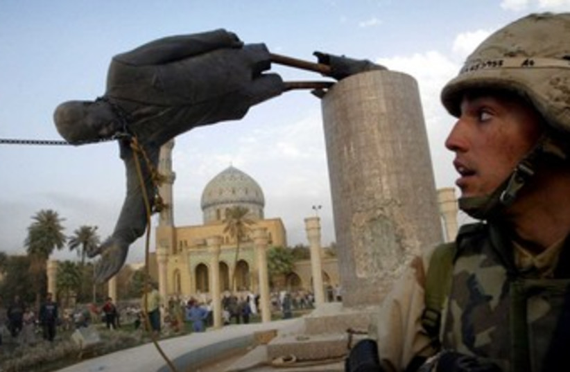 US marine watches as statue of Saddam Hussein falls 370  (photo credit: reuters)