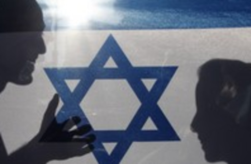 Shadow of couple on Israeli flag 300 (photo credit: Marc Israel Sellem)