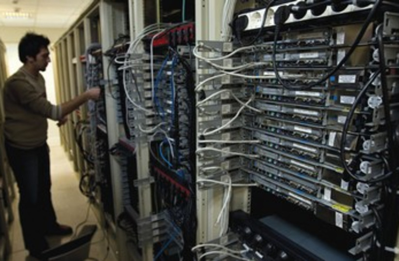 Engineer checks equipment at Tehran internet service 370 (photo credit: REUTERS)