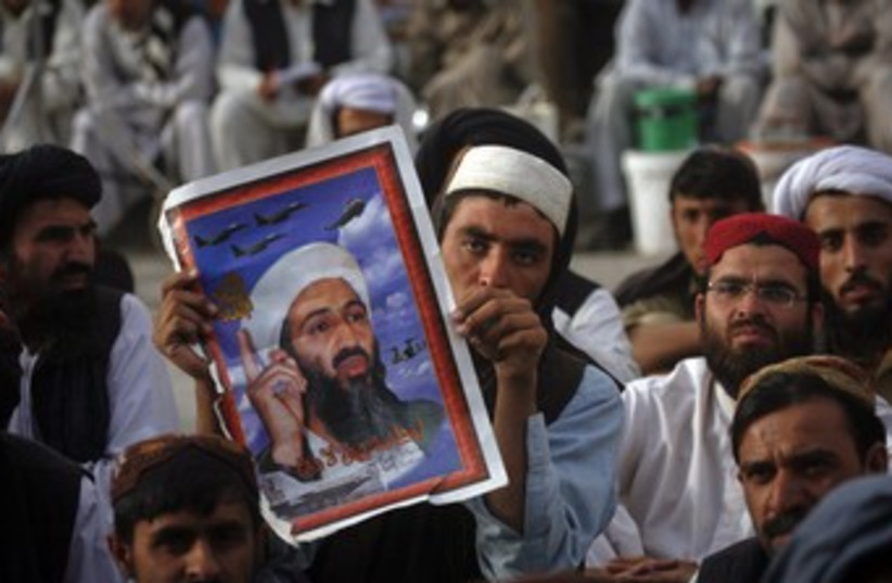 Pakistanis holding Bin Laden poster 370 (photo credit: Naseer Ahmed / Reuters)