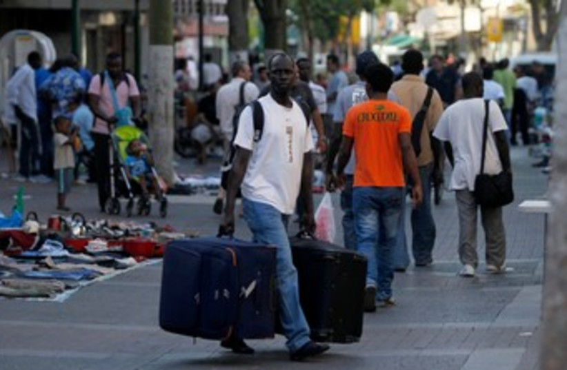 African migrant walks with suitcase in south Tel Aviv 370 (R (photo credit: REUTERS/Baz Ratner )