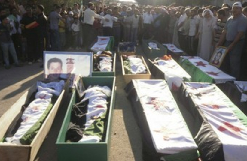 Syrian coffins 370 (photo credit: REUTERS)