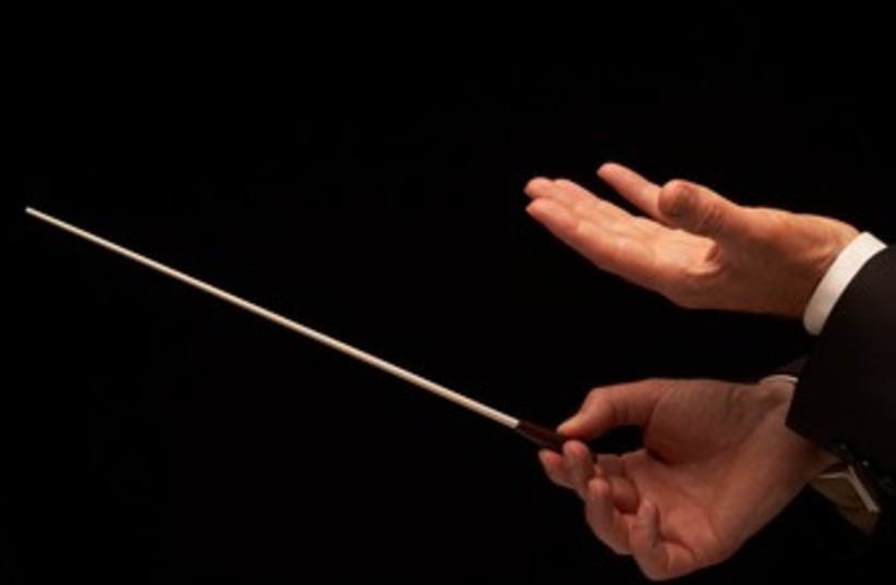 Concert conductor holds baton 370 (photo credit: Thinkstock/Imagebank)
