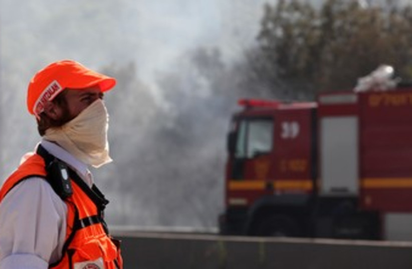 Rescue worker looks at Jerusalem fire 370 (photo credit: Marc Israel Sellem)