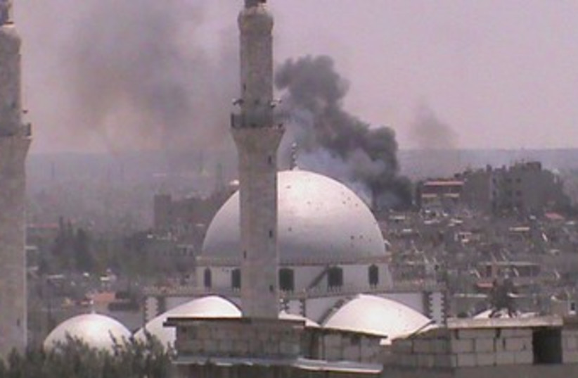 Smoke rises over Syria's Homs 370 (R) (photo credit: REUTERS / Handout)