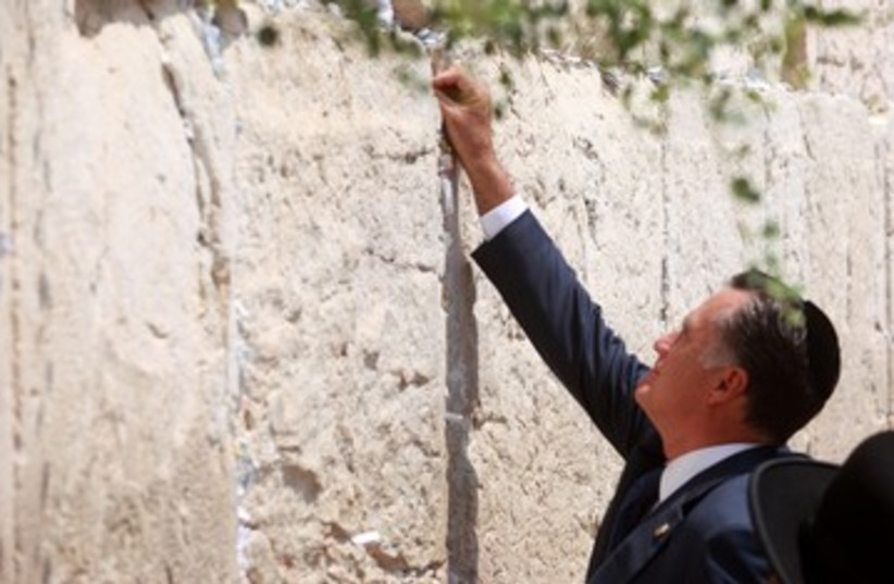 Mitt Romney puts a note in the Western Wall (photo credit: Marc Israel Sellem/The Jerusalem Post)