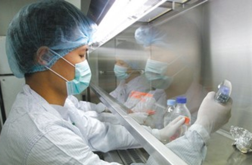 RESEARCHER Hoang Anh Duc researches dengue fever in Hanoi (photo credit: REUTERS)