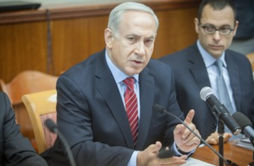 Netanyahu at cabinet meeting 370 (photo credit: Pool/Eli Selman)