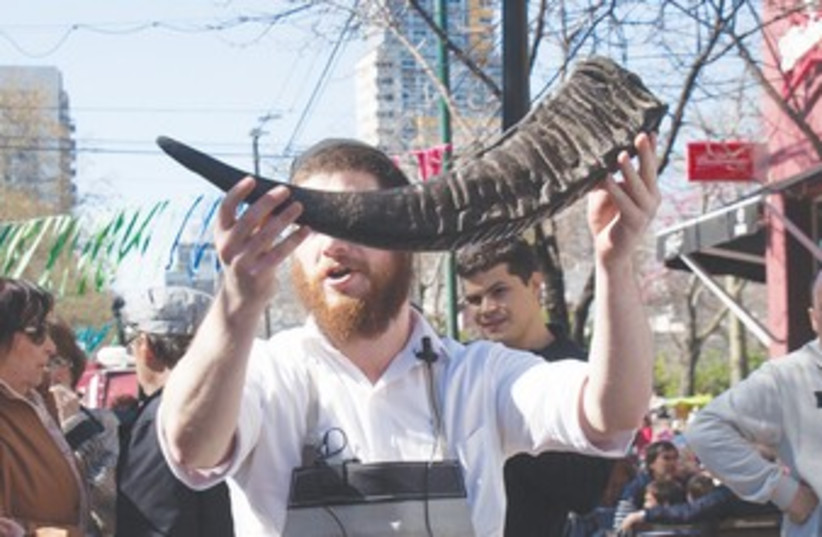 Man holds shofar at Buenos Aires Rosh Hashana festival 370 (photo credit: JDC)