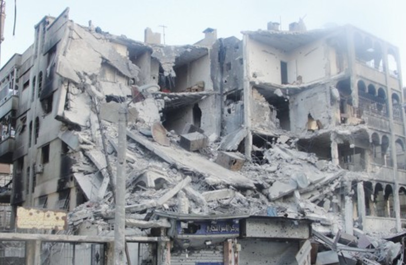 Destroyed houses in Homs (photo credit: Reuters)