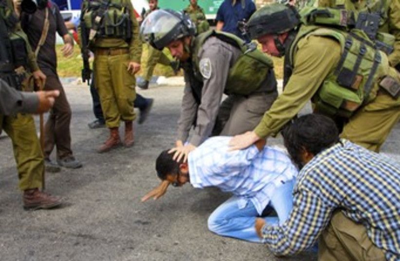 Palestinian protestor arrested 370 (photo credit: TOVAH LAZAROFF)