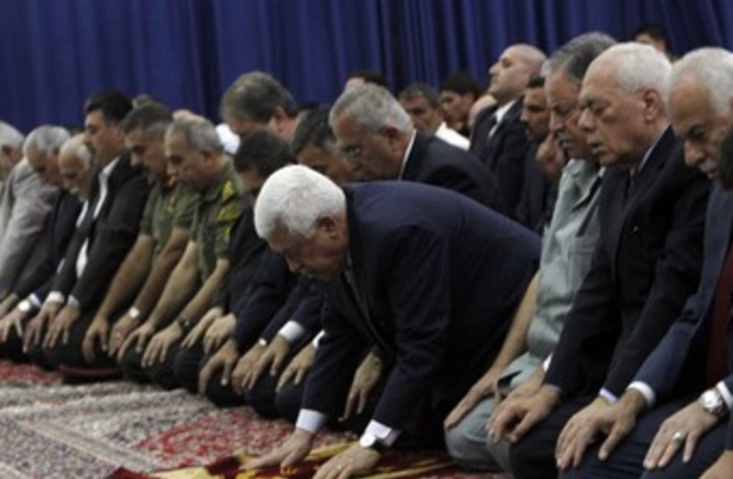 PA President Mahmoud Abbas praying 370 (photo credit: REUTERS/Mohamad Torokman)